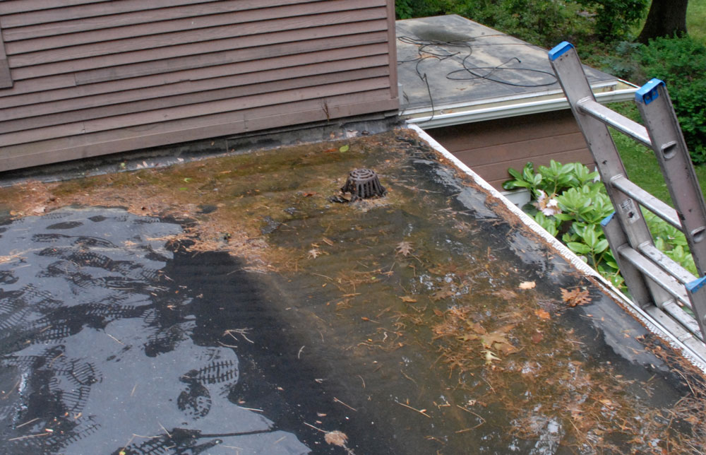 Flat Roof Drains - This drain was installed unnecessarily and too close to the wall. Flat Roof Drains - This drain was installed unnecessarily and too close to the wall.