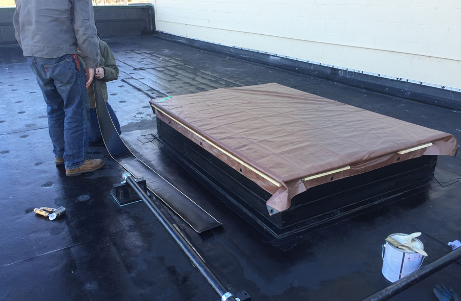 Covering a A/C curb with a tarp awaiting for unit installation