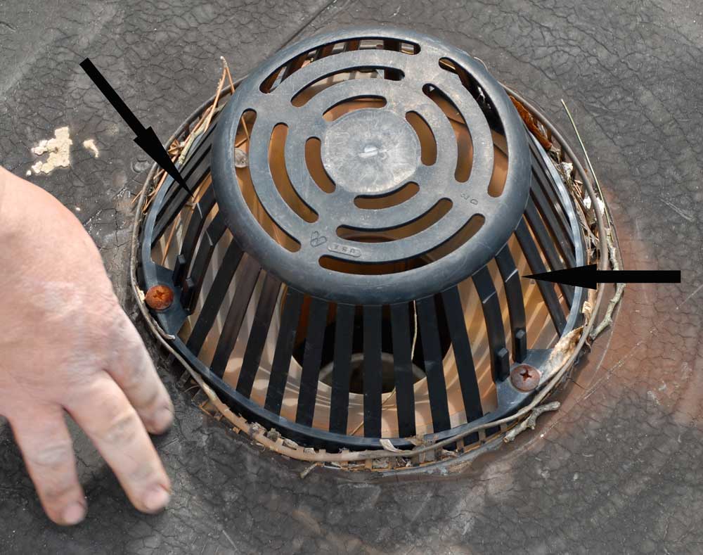 Flat Roof Drain Leaks Repaired - Flat Roof Drains and Strainers - Notice the cracks on this plastic strainer. Eventually, the strainer will develop more cracks, then break apart, and become ineffective. Flat Roof Drains and Strainers - Notice the cracks on this plastic strainer. Eventually, the strainer will develop more cracks, then break apart, and become ineffective.