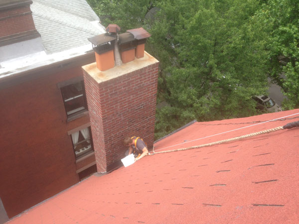 Rappelling to repair flashing on a chimney in Brooklyn, NY. Rappelling to repair flashing on a chimney in Brooklyn, NY.