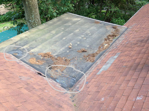 This EPDM Rubber roof shows that a repair was needed due to repeated foot traffic used to access the sloped roof. This EPDM Rubber roof shows that a repair was needed due to repeated foot traffic used to access the sloped roof.